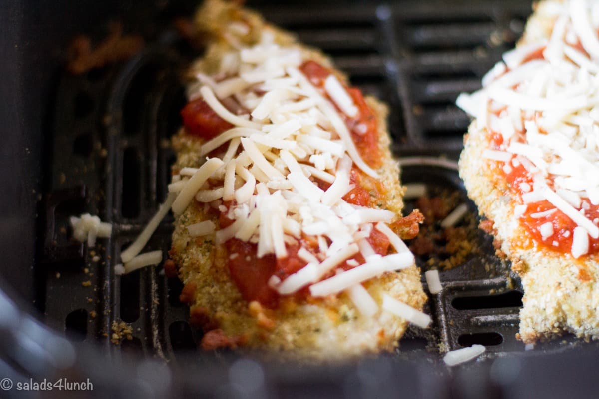 Air Fryer Chicken Parmesan 8 - Making this air fryer chicken parmesan is easy to do and takes half the time than it does in the conventional oven. Crispy and delicious! Garnish with parsley, serve with Easy Air Fryer Broccoli and enjoy!!