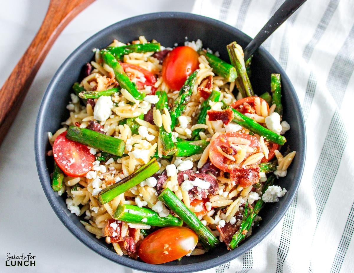 Asparagus and Bacon Orzo Salad Recipe 11 - Spring is officially in full bloom, and that means it’s time to celebrate all the amazing spring salad ingredients May has to offer! 🌷💚 From sweet strawberries to crisp asparagus, the produce aisle is bursting with color—and flavor. And what better way to use all that seasonal goodness than in a delicious salad?