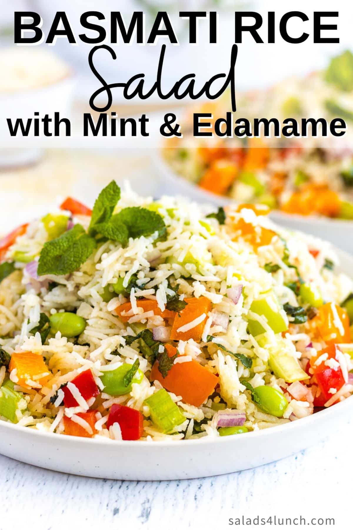 Close up of basmati rice salad with peppers, celery, mint and edamame on a white plate with text overlay that says: Basmati Rice Salad with Mint & Edamame.