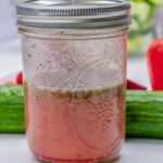 Close up of greek salad dressing in a mason jar.