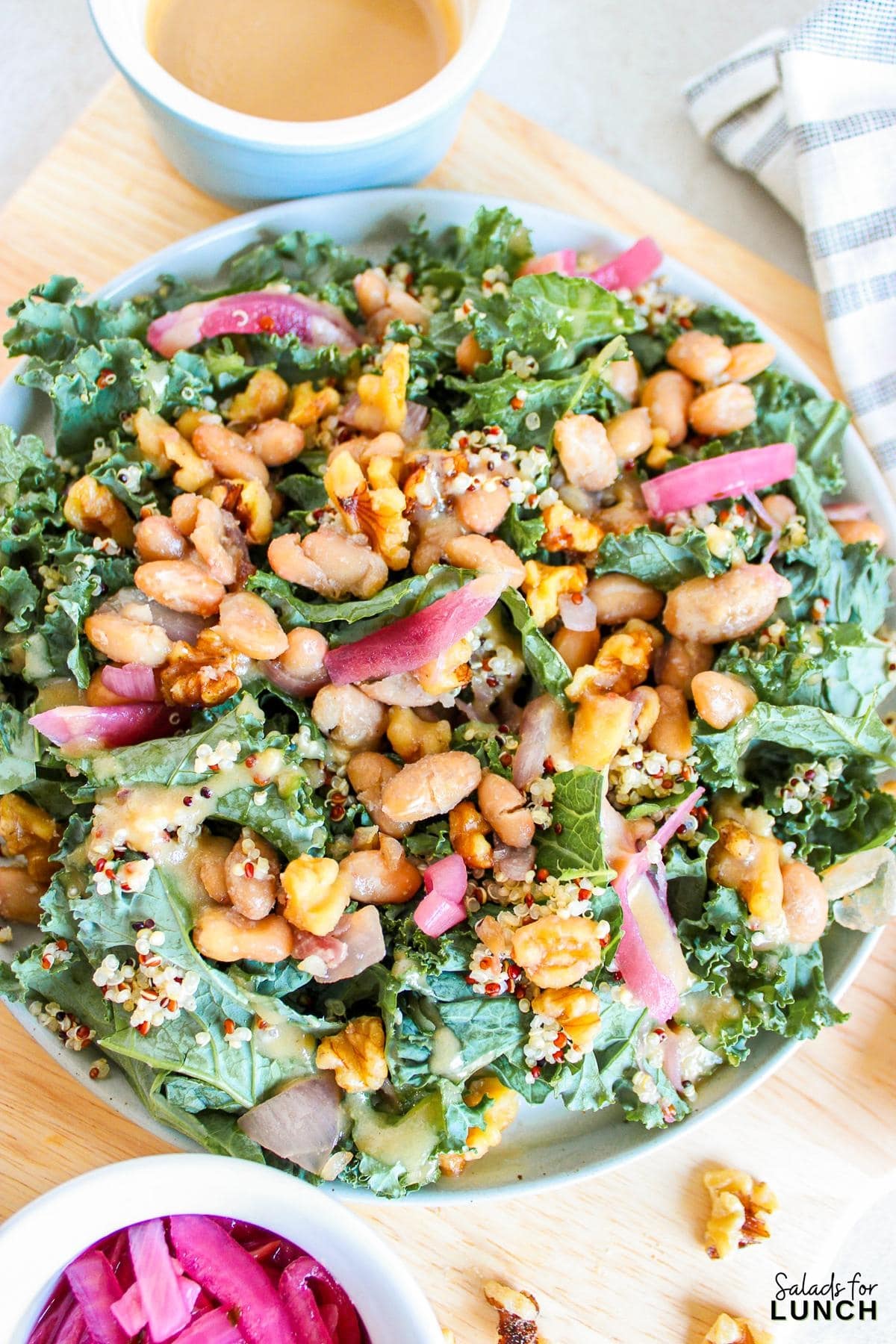 Butterbean and Walnut Kale Salad with Maple Tahini Dressing Recipe 11 - A warm and hearty vegan and gluten-free kale salad featuring quinoa, sautéed butter beans, shallots, and walnuts, all topped with a luscious maple tahini dressing.