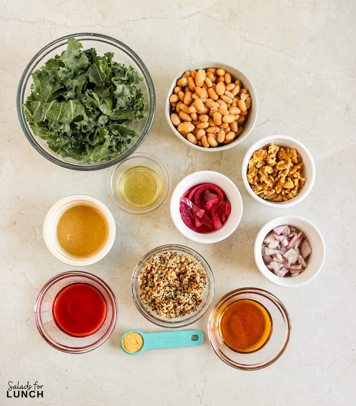 Butterbean and Walnut Kale Salad with Maple Tahini Dressing Recipe 2 - A warm and hearty vegan and gluten-free kale salad featuring quinoa, sautéed butter beans, shallots, and walnuts, all topped with a luscious maple tahini dressing.