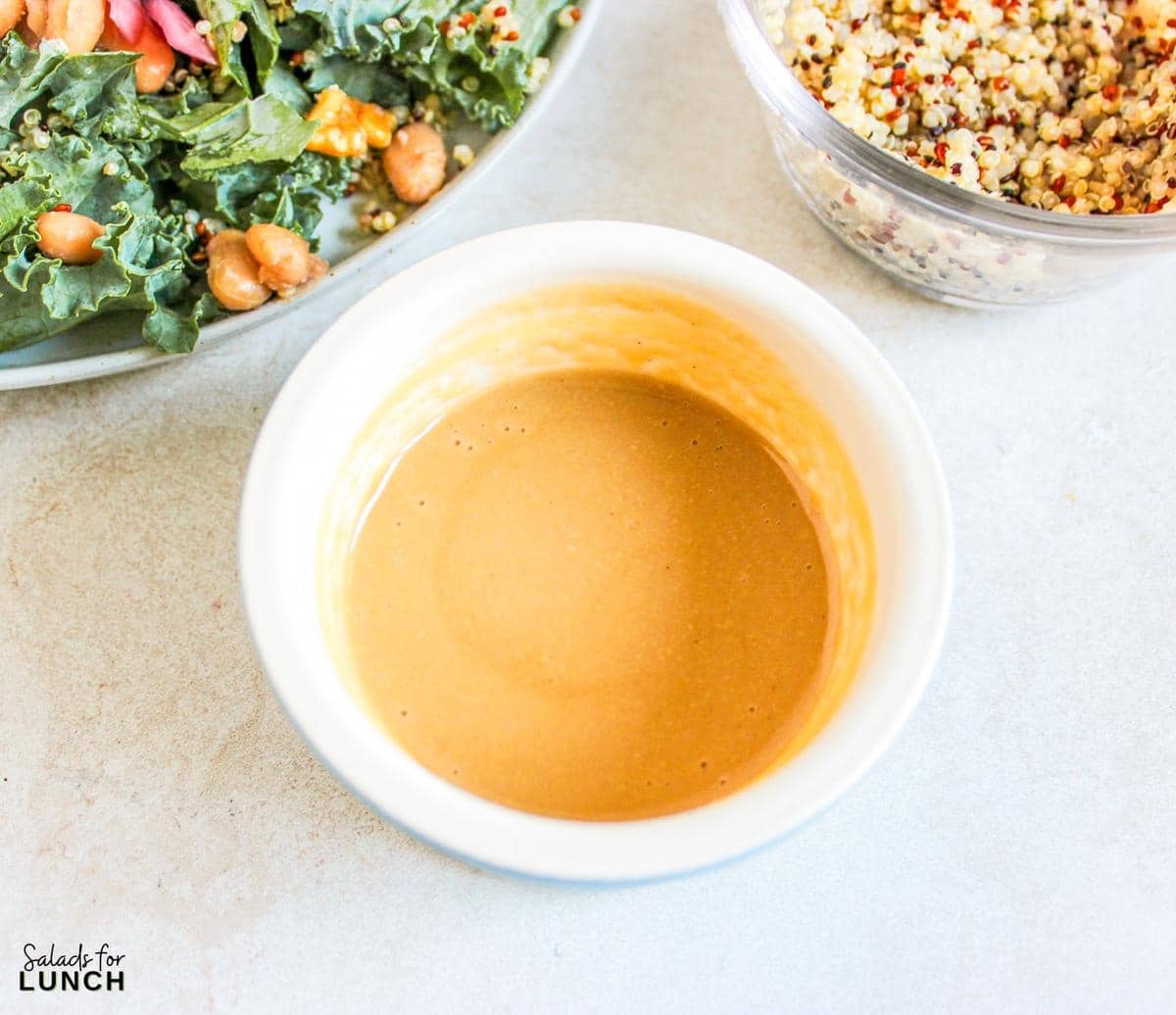 Butterbean and Walnut Kale Salad with Maple Tahini Dressing Recipe 6 - A warm and hearty vegan and gluten-free kale salad featuring quinoa, sautéed butter beans, shallots, and walnuts, all topped with a luscious maple tahini dressing.