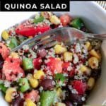Close up of white bowl showing quinoa salad with corn, black beans, red peppers, and green peppers with text overlay: Corn and Black Bean Quinoa Salad