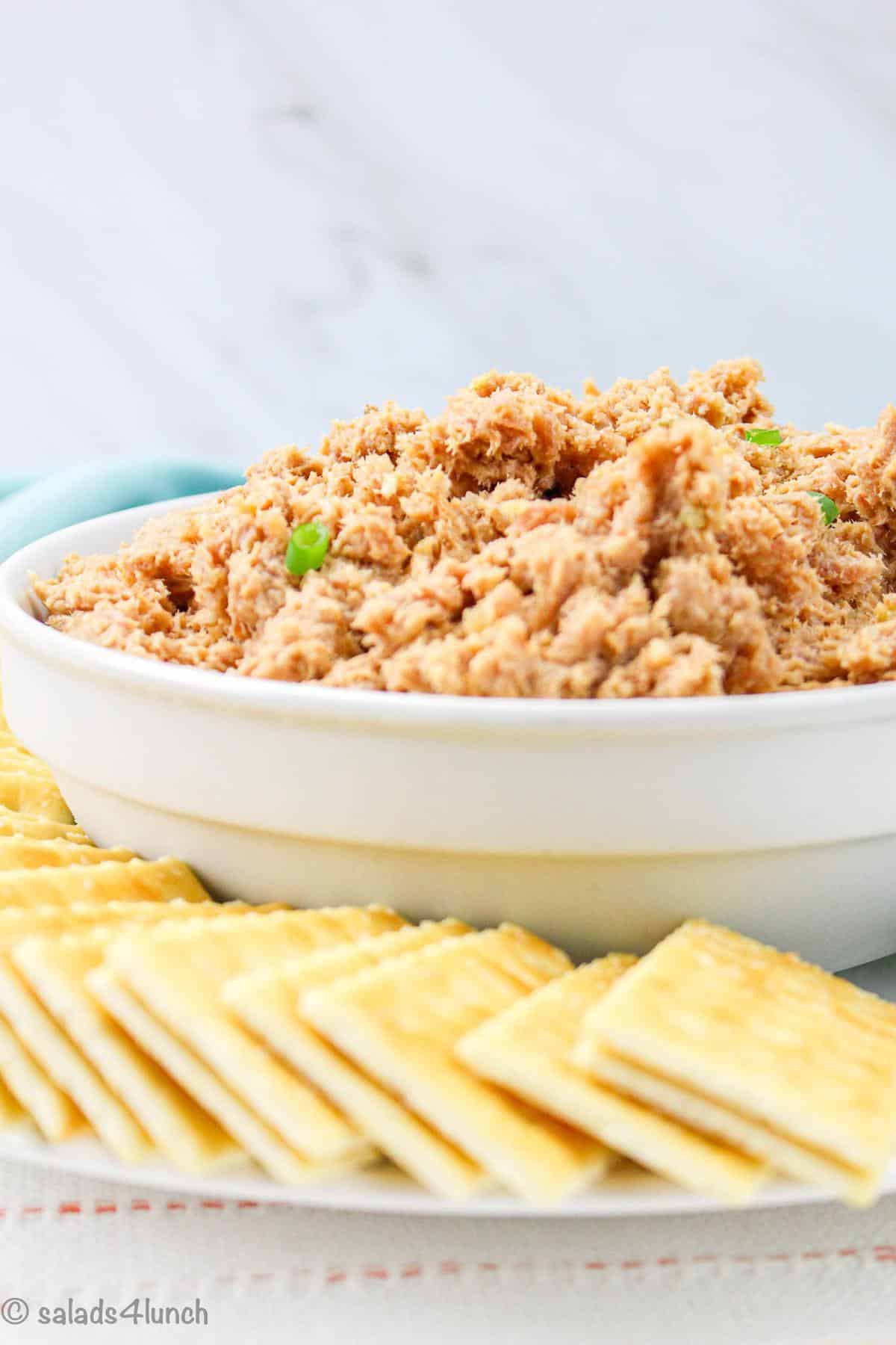 deviled ham spread in a white bowl with saltine crackers.