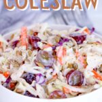 Creamy Coleslaw in a white bowl with grapes and sunflower seeds with text overlay that says: "Easy Creamy Coleslaw".