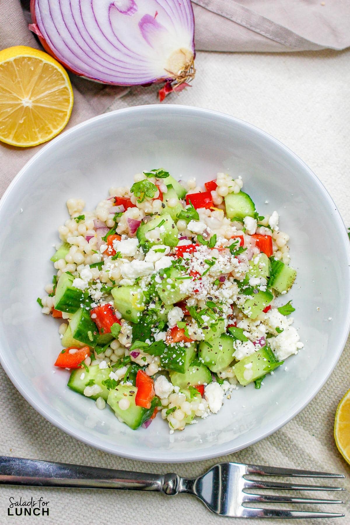 Easy Lemon Couscous Salad Recipe 17 - Zesty Lemon Couscous Salad - a refreshing and vibrant summer salad recipe bursting with citrusy flavors, feta cheese and crisp veggies!