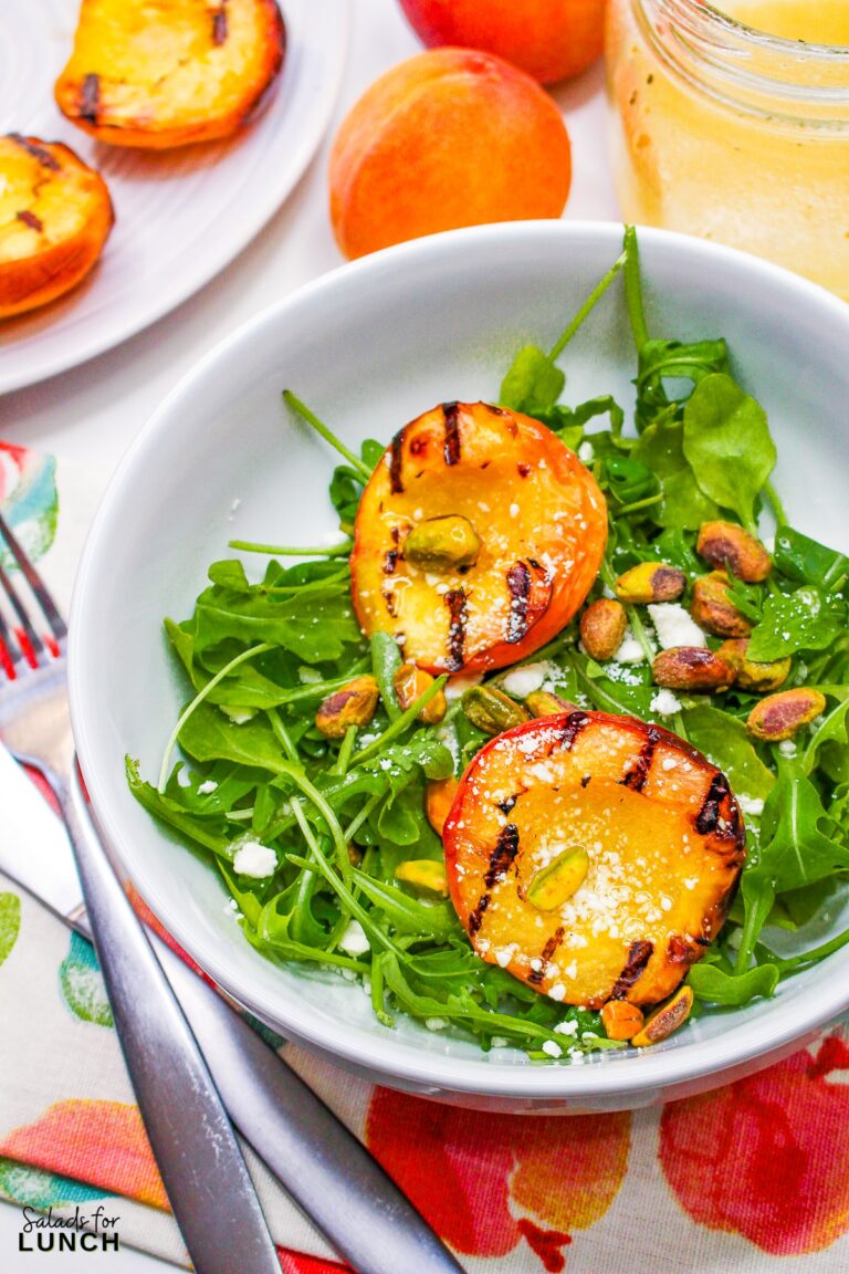 Indulge in the flavors of the season with our Grilled Peach Summer Salad! Arugula and pistachios complement the juicy peaches, creating a refreshing and elegant dish perfect for your late summer BBQs. Get ready to savor the taste of sunshine!