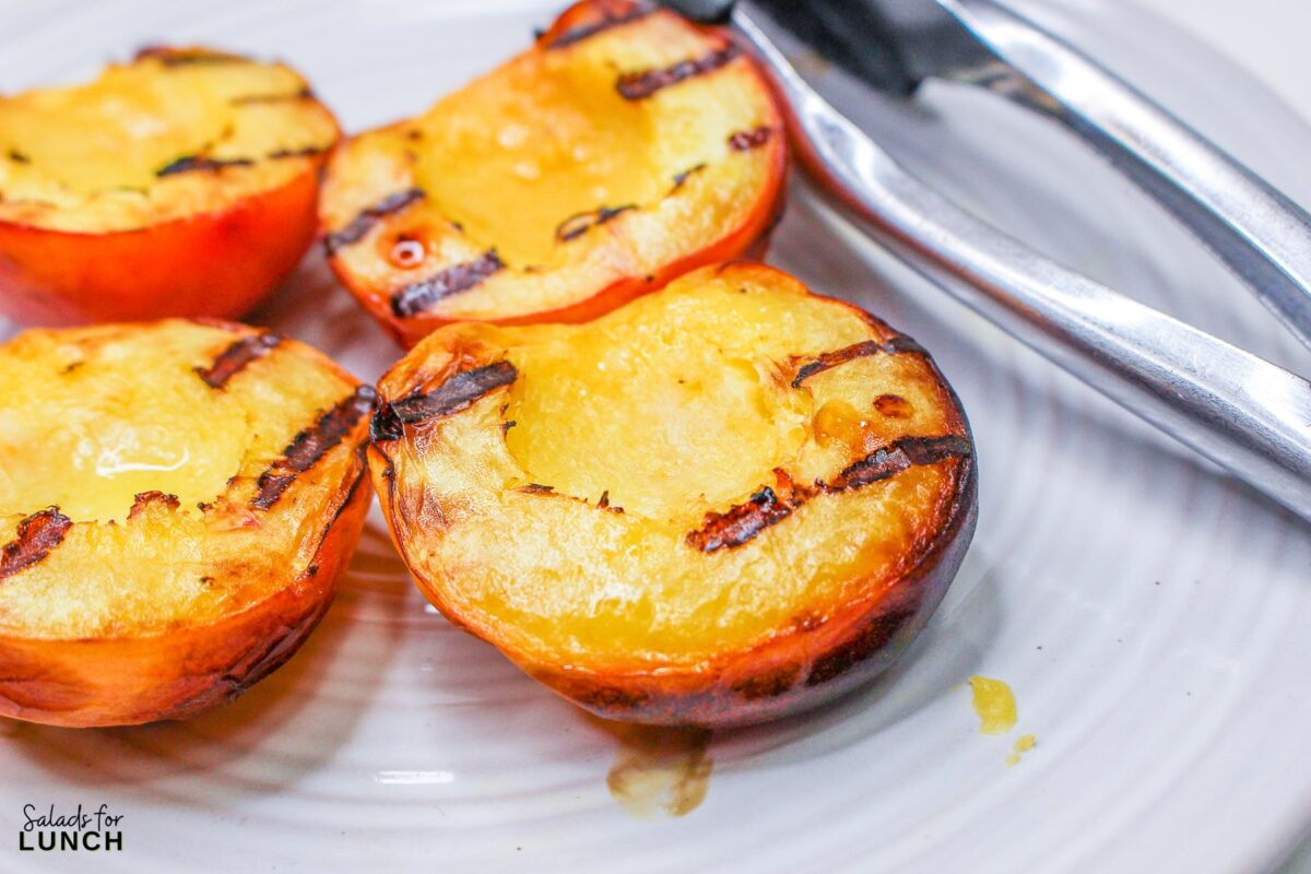 Grilled Peach Summer Salad 6 - Indulge in the flavors of the season with our Grilled Peach Summer Salad! Arugula and pistachios complement the juicy peaches, creating a refreshing and elegant dish perfect for your late summer BBQs. Get ready to savor the taste of sunshine!
