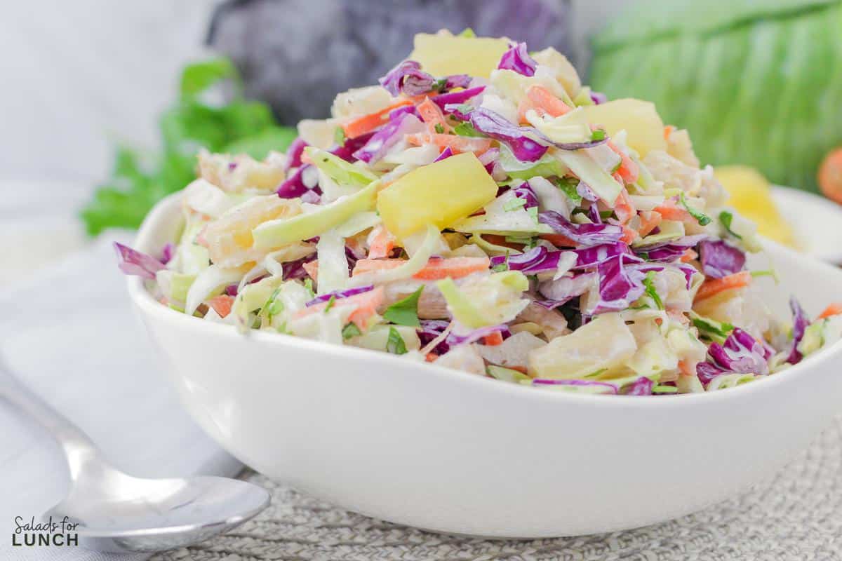Hawaiian Coleslaw 17 - Hawaiian Coleslaw with Pineapple puts a sweet and savory tropical twist on the classic picnic side dish. This recipe can be lightened-up with Greek yogurt, this easy summer salad is definitely not your average same old cole slaw recipe!