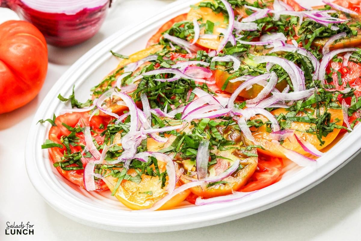 Heirloom Tomato Basil Salad Recipe 19 - This fresh and vibrant salad showcases the natural sweetness of heirloom tomatoes paired with the aromatic essence of basil. It's a perfect dish for a light lunch or as a side to complement your favorite summer meals.