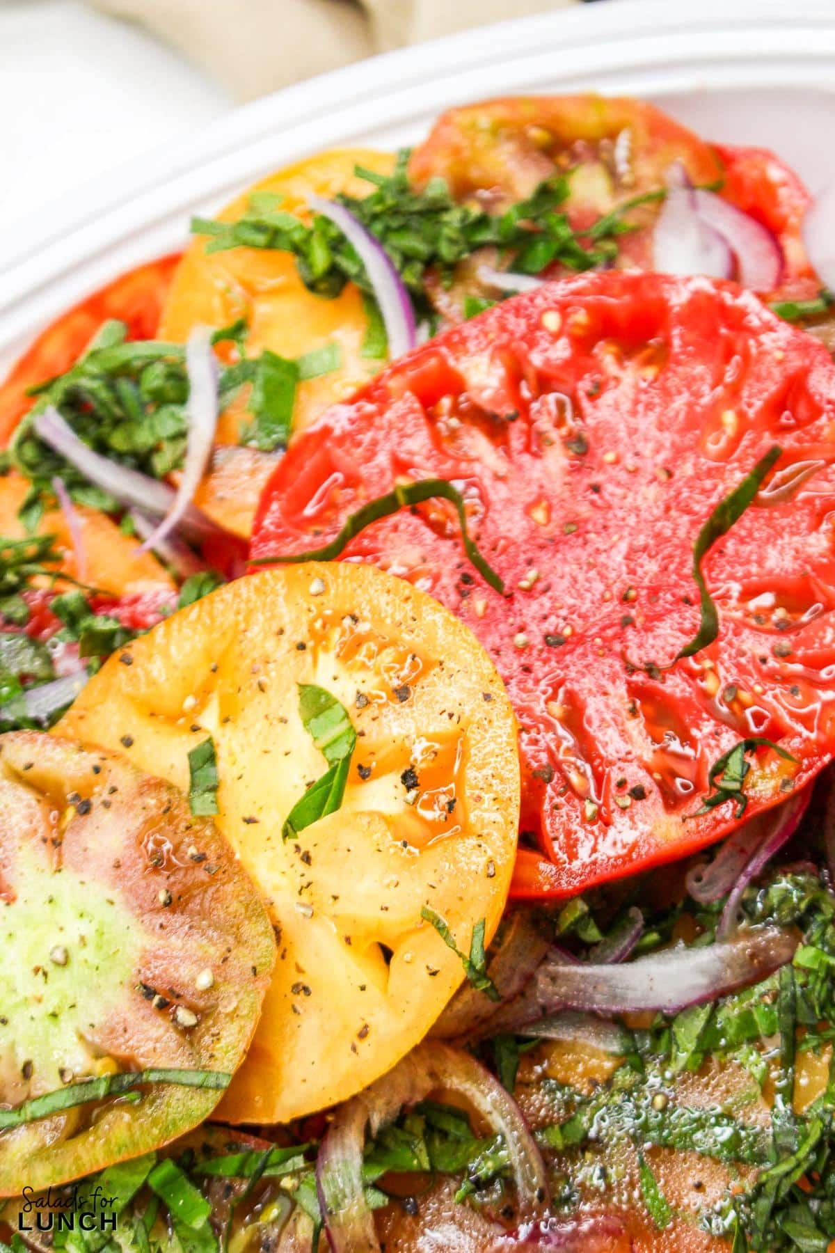 Heirloom Tomato Basil Salad Recipe 30 - This fresh and vibrant salad showcases the natural sweetness of heirloom tomatoes paired with the aromatic essence of basil. It's a perfect dish for a light lunch or as a side to complement your favorite summer meals.