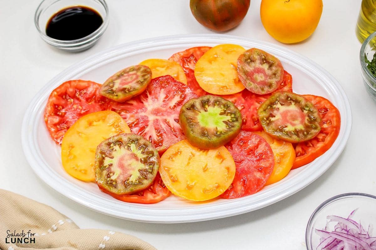 Heirloom Tomato Basil Salad Recipe 7 - This fresh and vibrant salad showcases the natural sweetness of heirloom tomatoes paired with the aromatic essence of basil. It's a perfect dish for a light lunch or as a side to complement your favorite summer meals.