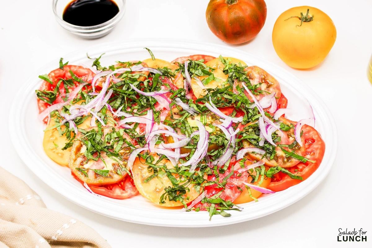 Heirloom Tomato Basil Salad Recipe 9 - This fresh and vibrant salad showcases the natural sweetness of heirloom tomatoes paired with the aromatic essence of basil. It's a perfect dish for a light lunch or as a side to complement your favorite summer meals.