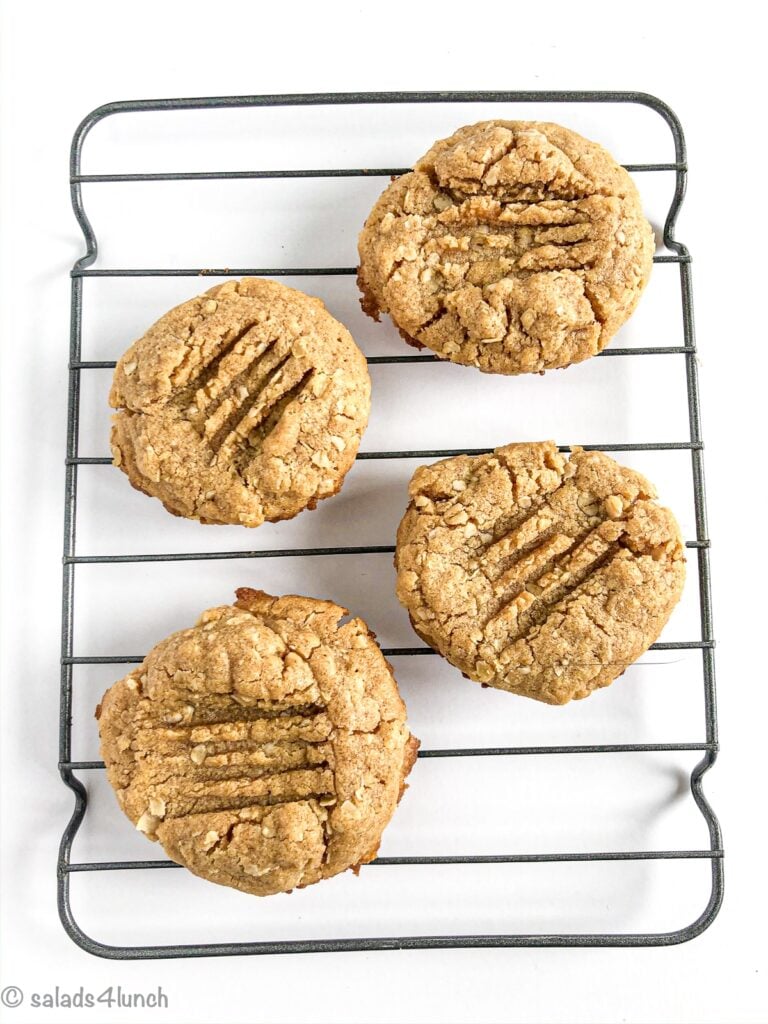 Peanut Butter Oatmeal cookies cooling on a rack with white backgrund