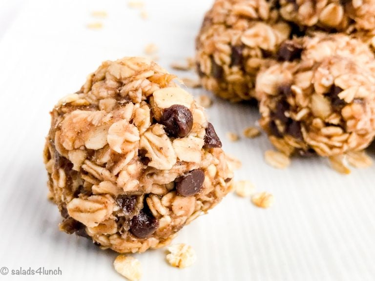 Close up of a peanut butter oate=meal banana and chocolate energy ball on a white plate