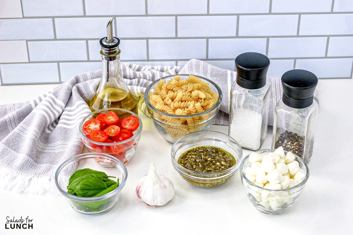 Pesto Caprese Pasta Salad 1 - This pasta salad is loaded with your favorite pasta noodles, fresh tomatoes and mozzarella and tossed in the best tasty pesto! It's such an easy dish and perfect for anytime of the year!
