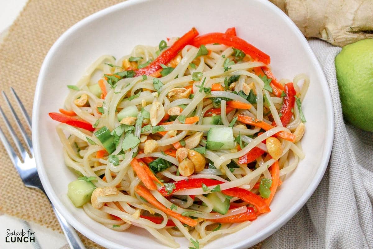 Rice Noodle Salad Recipe 11 - This refreshing salad features tender rice noodles tossed with crisp vegetables and a tangy sesame-lime dressing. It's perfect as a light main course or a flavorful side dish.