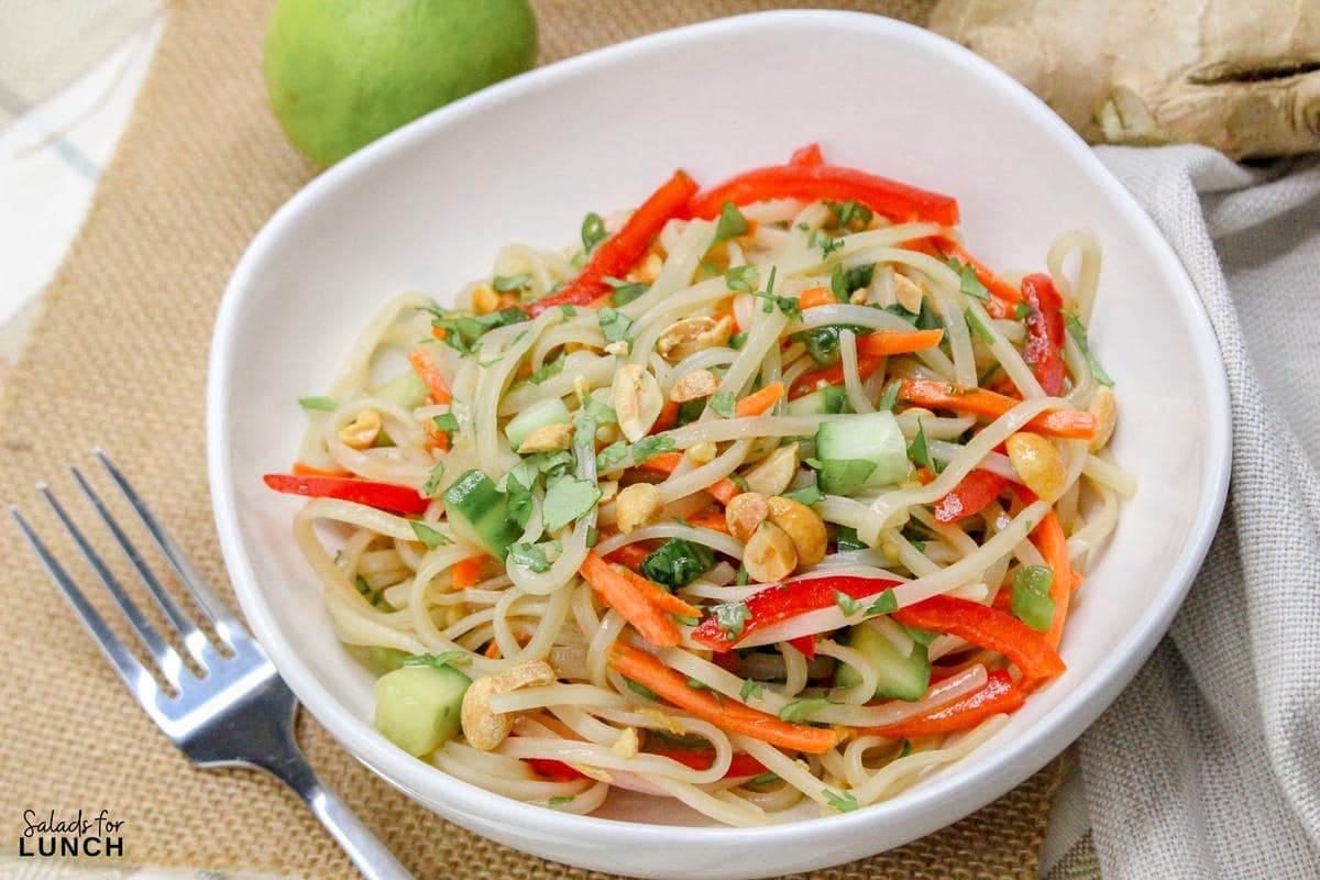 Rice Noodle Salad Recipe 13 - This refreshing salad features tender rice noodles tossed with crisp vegetables and a tangy sesame-lime dressing. It's perfect as a light main course or a flavorful side dish.