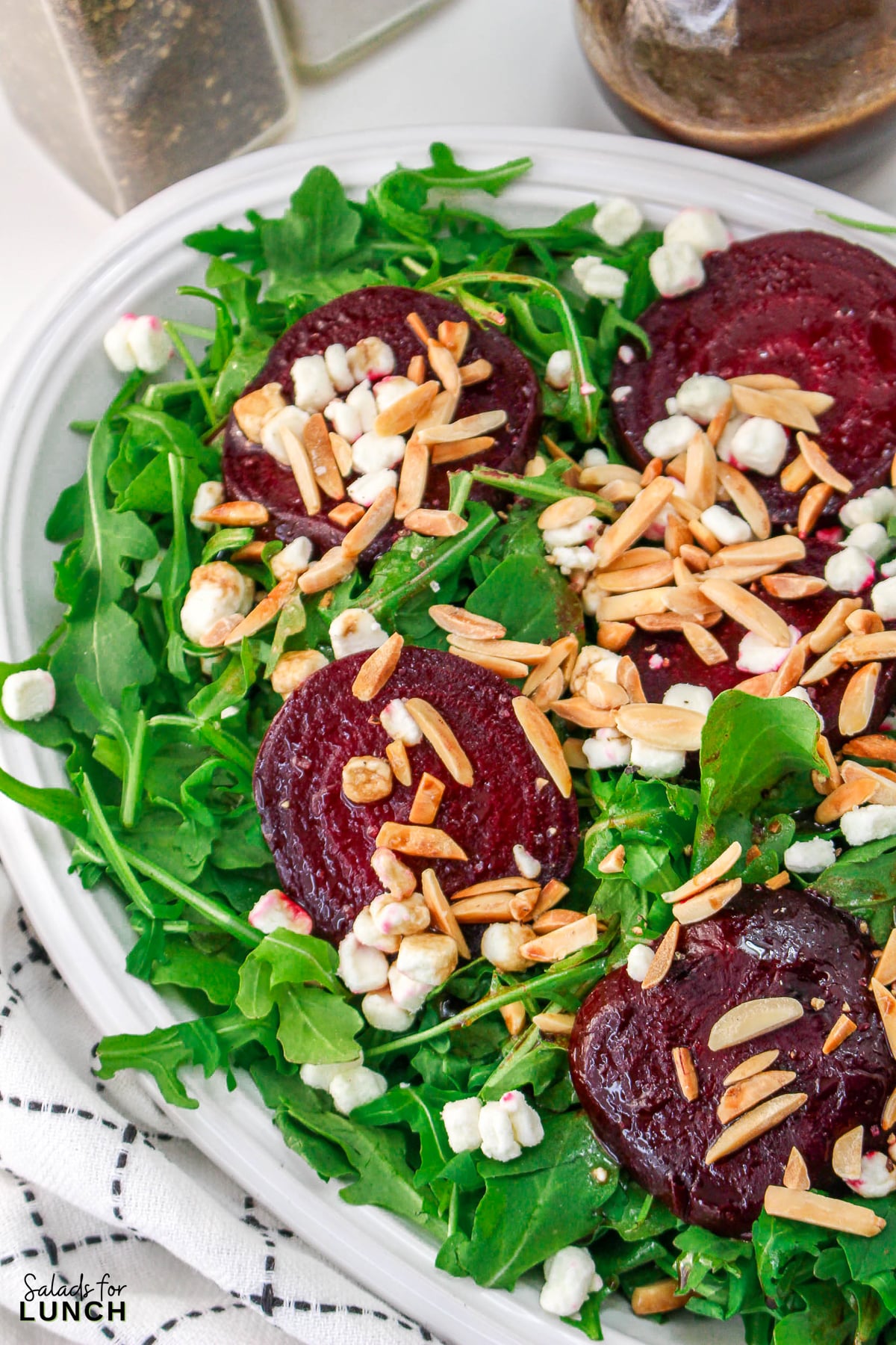 Roasted Beet Salad Recipe 25 1 - With the festive hues of red beets, green arugula, and golden slivered almonds, this Christmas salad recipe is a celebration of flavors and a feast for the eyes that will make your holiday spread merry and bright!