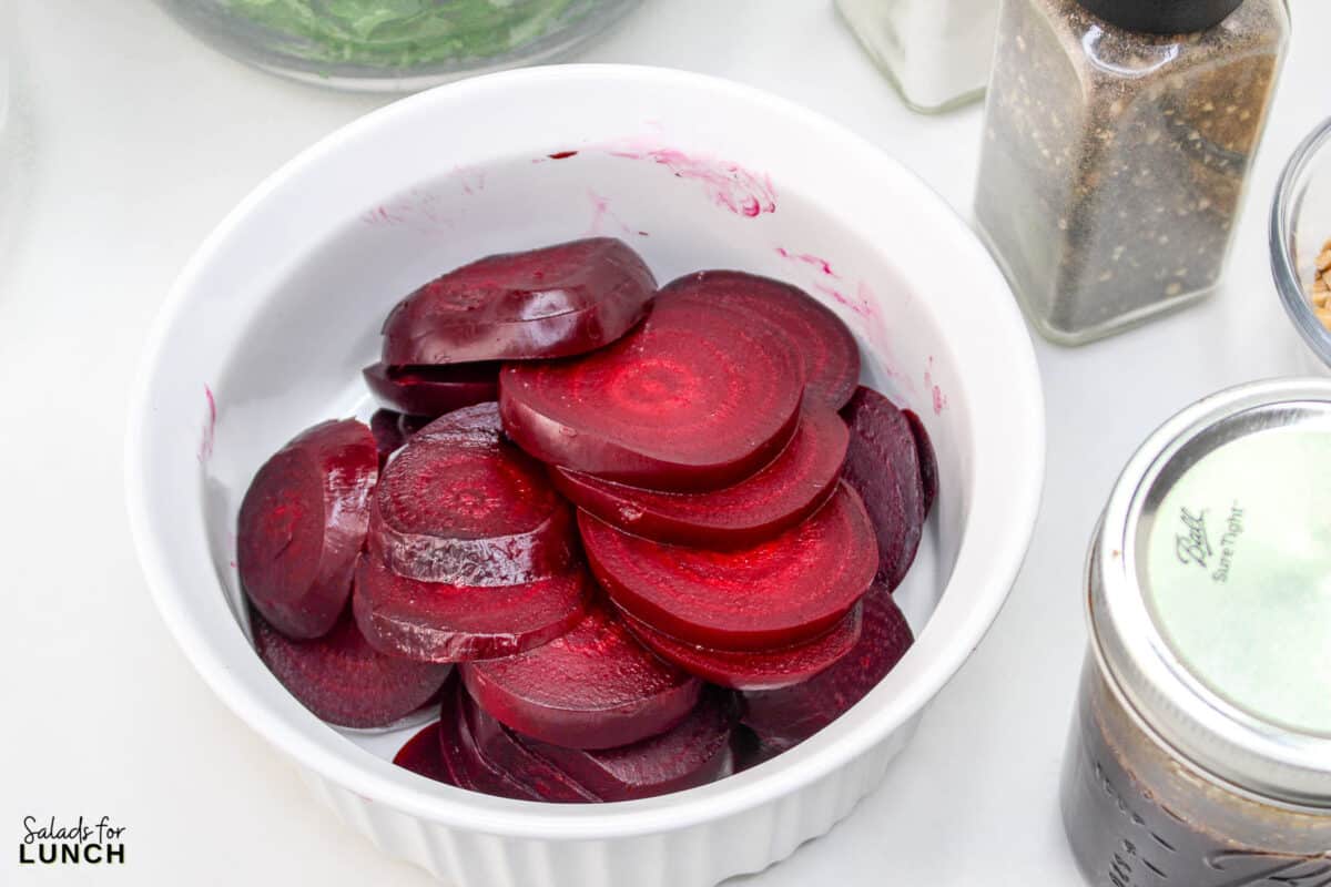 Roasted Beet Salad Recipe 9 1 - With the festive hues of red beets, green arugula, and golden slivered almonds, this Christmas salad recipe is a celebration of flavors and a feast for the eyes that will make your holiday spread merry and bright!