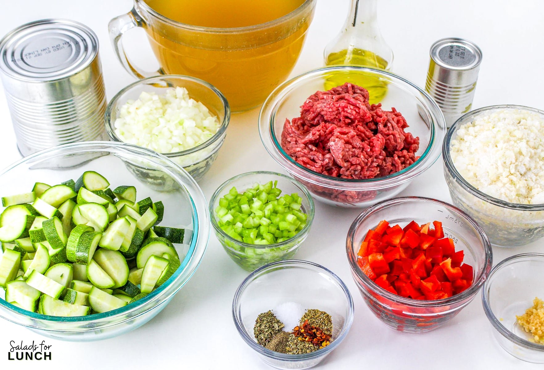 Side shot of ingredients needed to make a zucchini soup in a slow cooker.