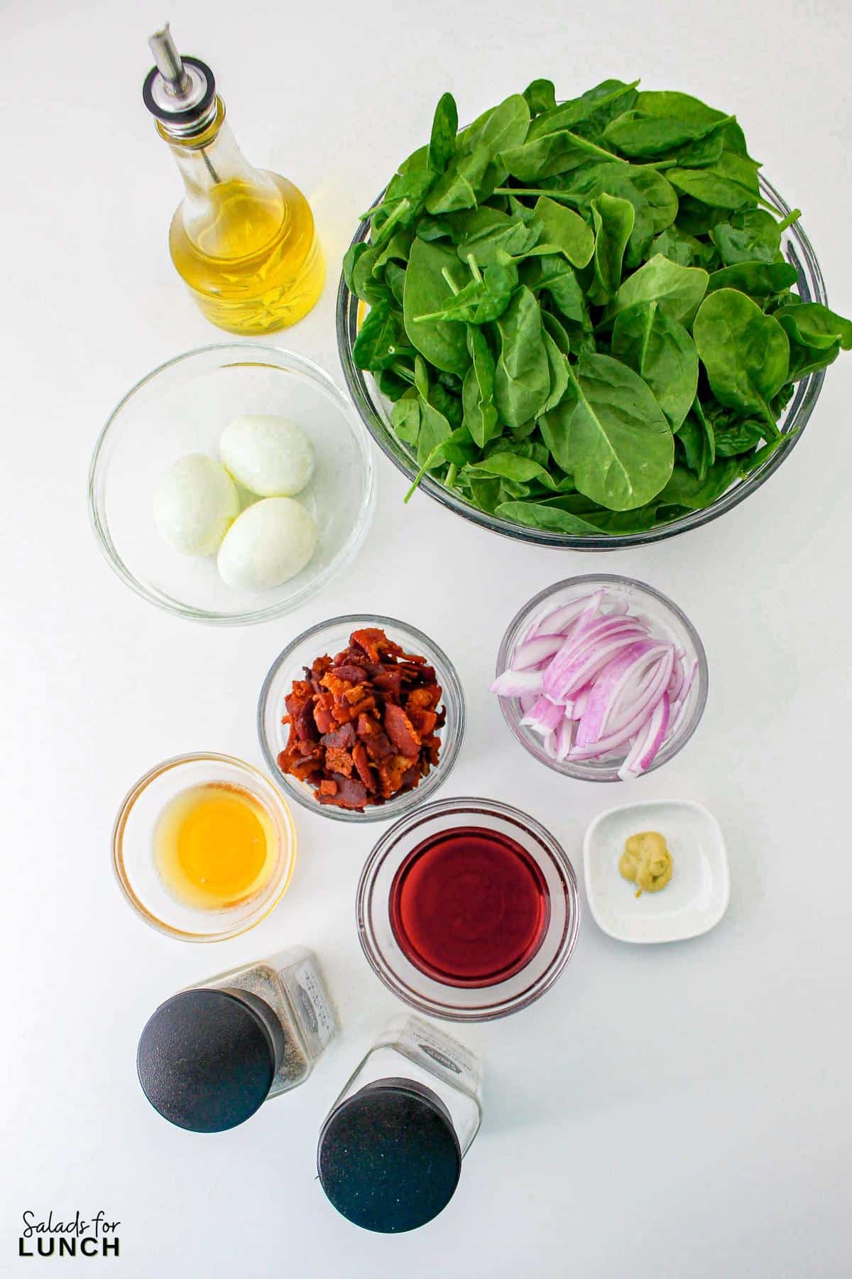 Spinach Salad with Eggs and Bacon Recipe 2 - Crisp baby spinach leaves, creamy hard-boiled eggs, savory bacon crumbles, and tangy red onion come together in perfect harmony, topped with a drizzle of homemade red wine vinegar dressing. It’s a satisfying spinach, egg and bacnon salad that’s as easy to make as it is delicious to eat!