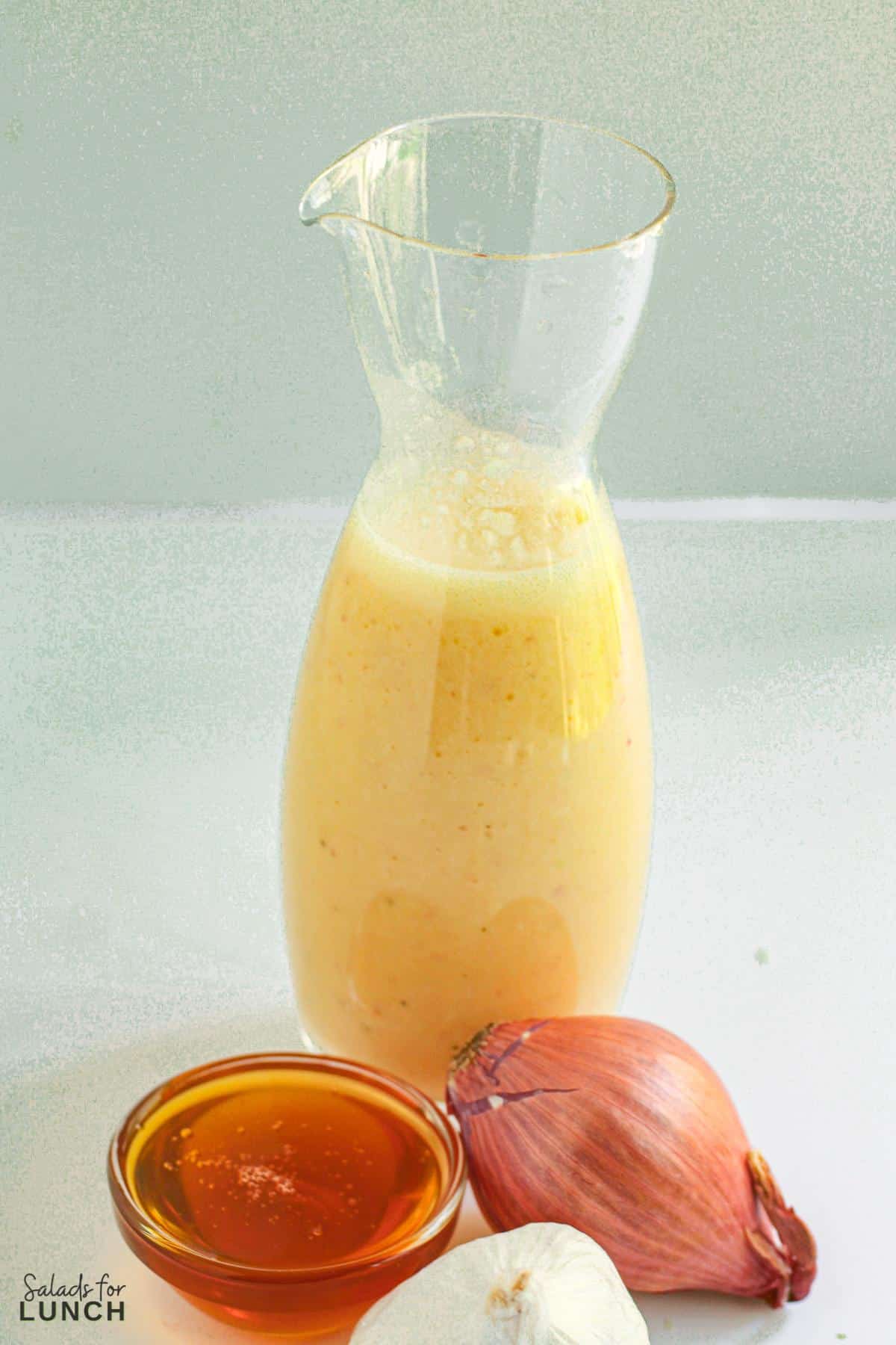 White balsamic salad vinaigrette salad dressing in a glass jar.