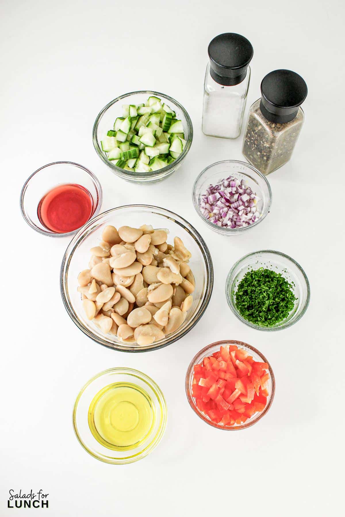 A group of bowls of ingredients for butter bean salad.