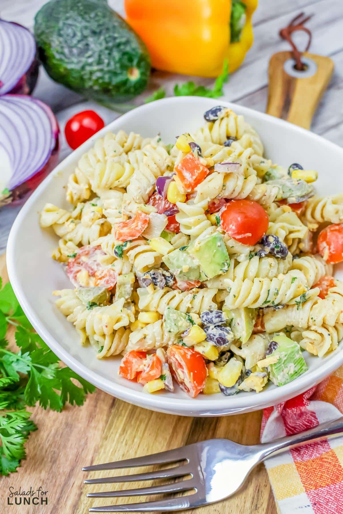 Vegetarian Mexican Pasta Salad - Vegetarian Mexican Pasta Salad 27 Featured image of of a mexican pasta salad in a white bowl with black beans, cilantro, avocado, tomato, and corn.