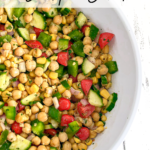 Cilantro lime chickpea salad in a white bowl on white wood countertop